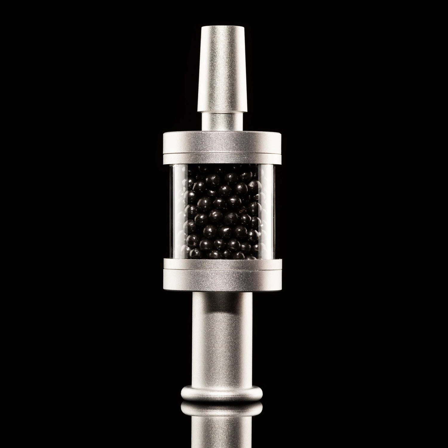 Silver Flux Pike tar filter mounted on stem, clear chamber filled with carbon media, 14 mm bong filter shown on black.