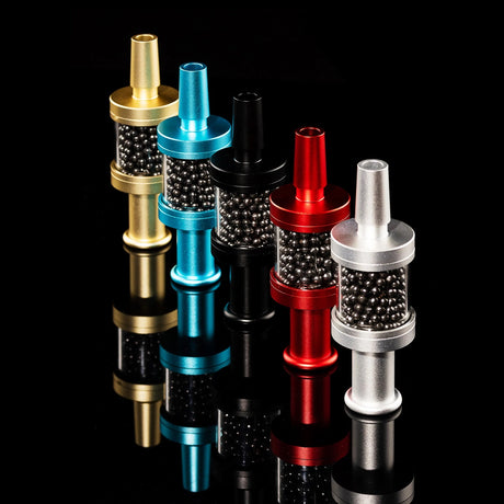 Lineup of Flux Pike tar filters in assorted colors with reflective base, carbon media chambers visible, 14 mm bong filters.