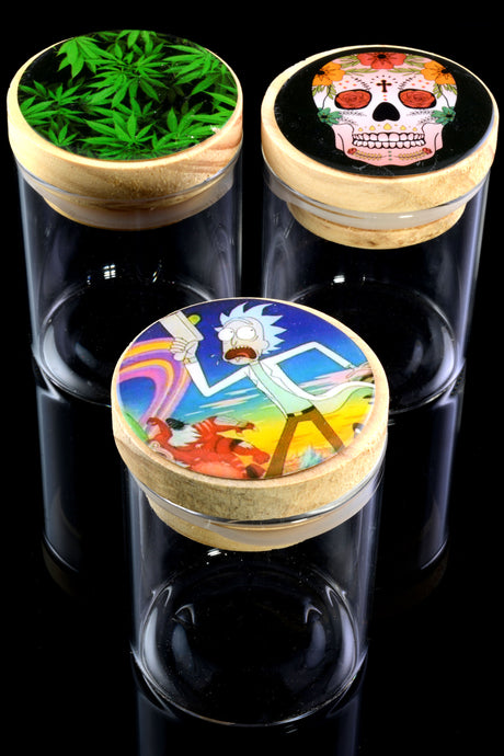 Trio of bamboo-lid glass jars on glossy black surface featuring cannabis leaf, sugar-skull and Rick cartoon decal designs, highlighting assorted artwork