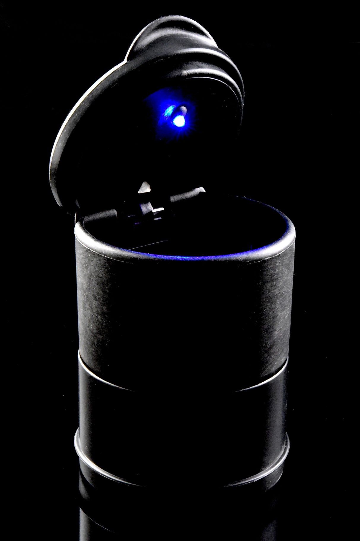 Open black LED cup holder ashtray glowing blue inside, shot on glossy black surface, high-contrast product photo.
