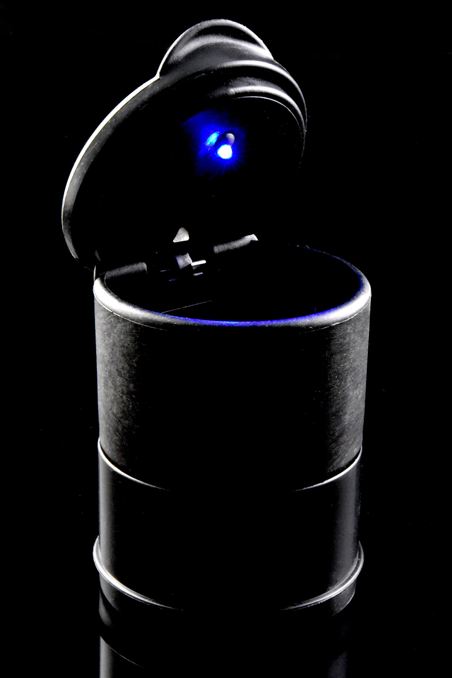 Open black LED cup holder ashtray glowing blue inside, shot on glossy black surface, high-contrast product photo.