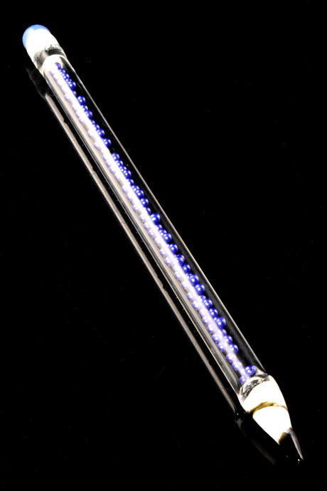 Single violet-core glass bead pencil dab tool featuring blue eraser cap, striped ferrule, and precision glass point, displayed diagonally on black backdrop.