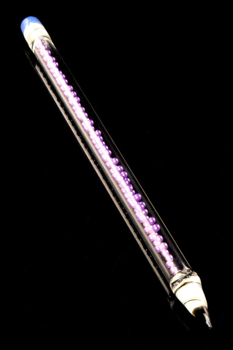 Single lavender-core glass bead concentrate tool with clear body and fine tapered point, photographed on glossy black surface for color contrast.