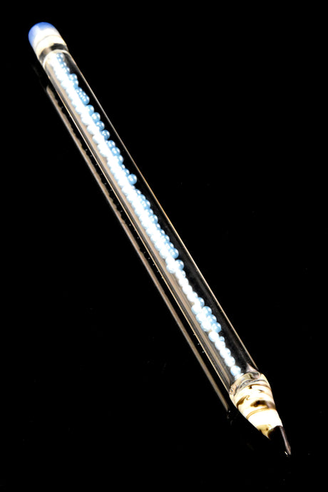 Single ice-blue bead pencil glass dabber with transparent barrel and blue eraser cap, angled on black background to highlight internal pearl array.