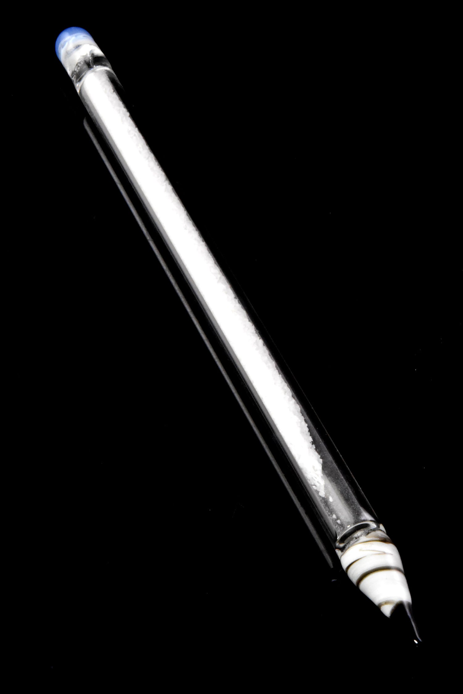 Single clear-core glass pencil dabber featuring white frit interior, blue “eraser” cap, and fine glass point, photographed on black backdrop.
