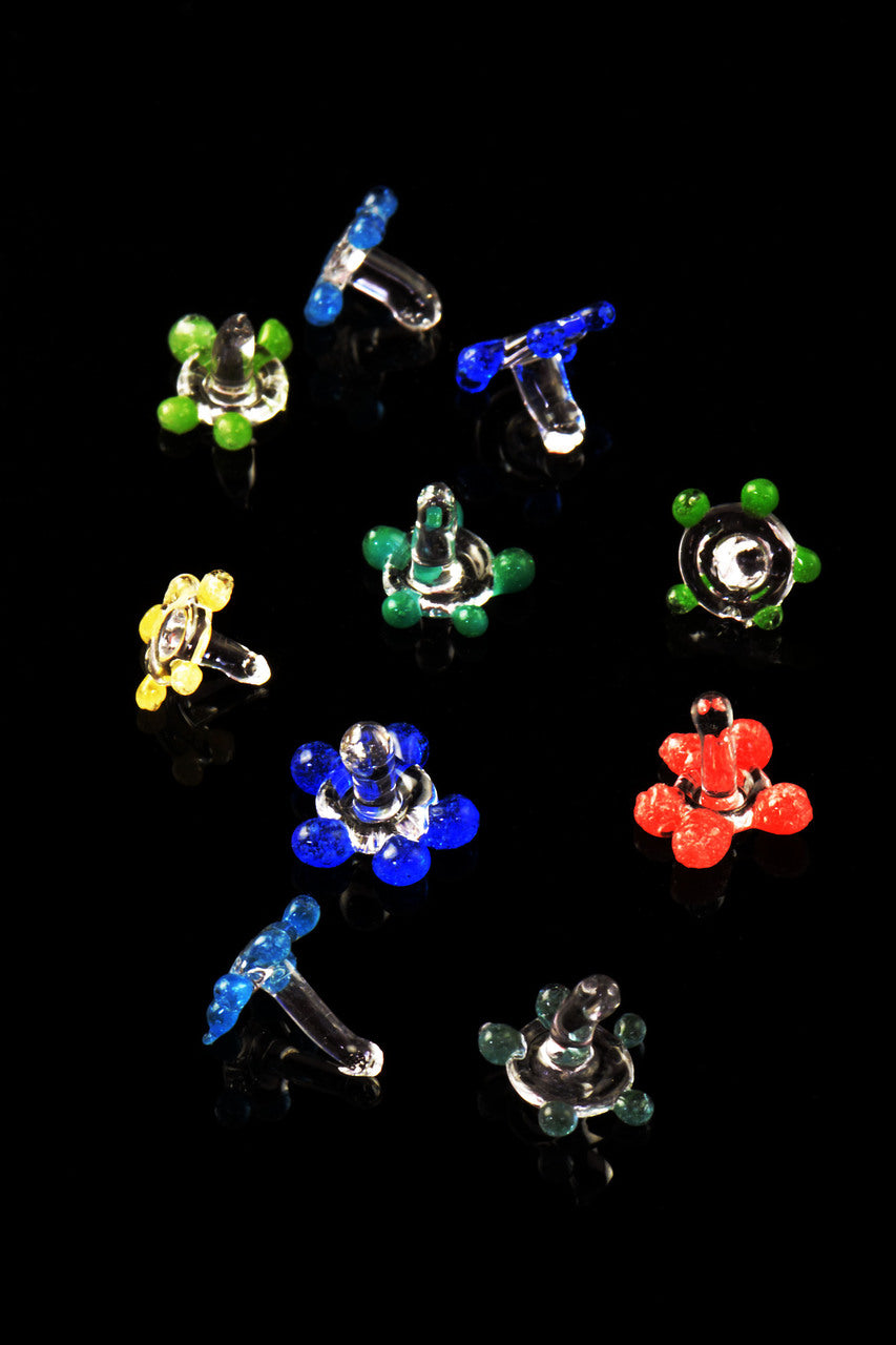 Close-up of assorted glass daisy pipe screens on a black background, highlighting petal shapes and mixed colors.