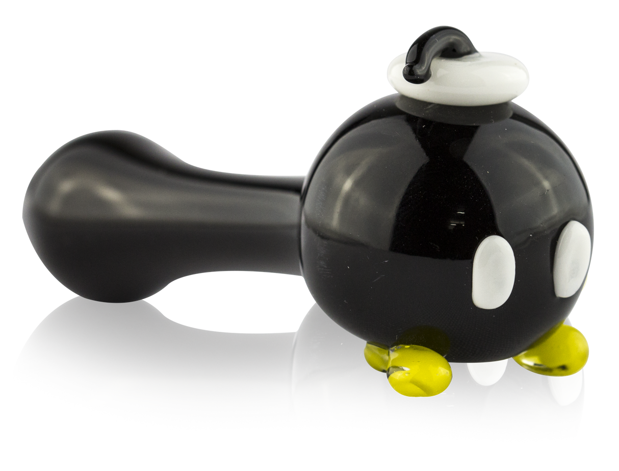 Side profile of 4″ glass hand pipe with black bomber body, white eyes, yellow feet, and raised fuse detail
