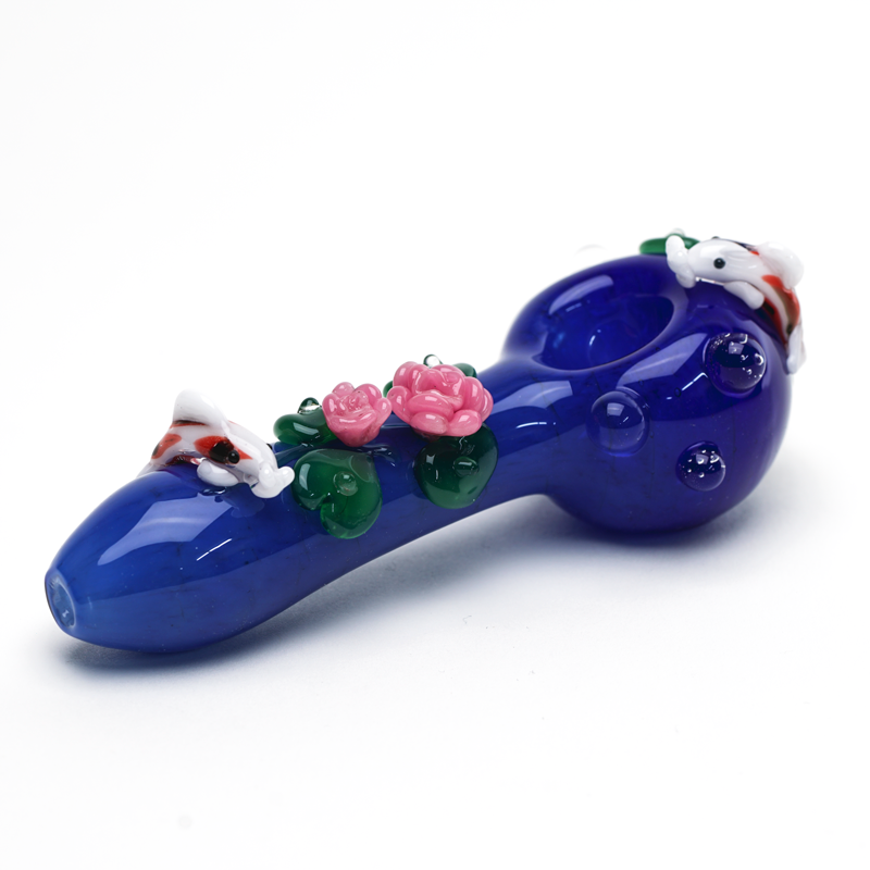 Three-quarter view of Empire Glassworks hand pipe with blue pond design, koi accents, and floral glasswork