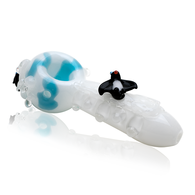Side profile of 4½″ glass hand pipe showing aqua ice-like marbles and penguin-themed details