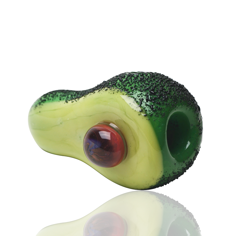 Side profile of compact avocado hand pipe with green glass bowl, raised peel texture, and pit detail