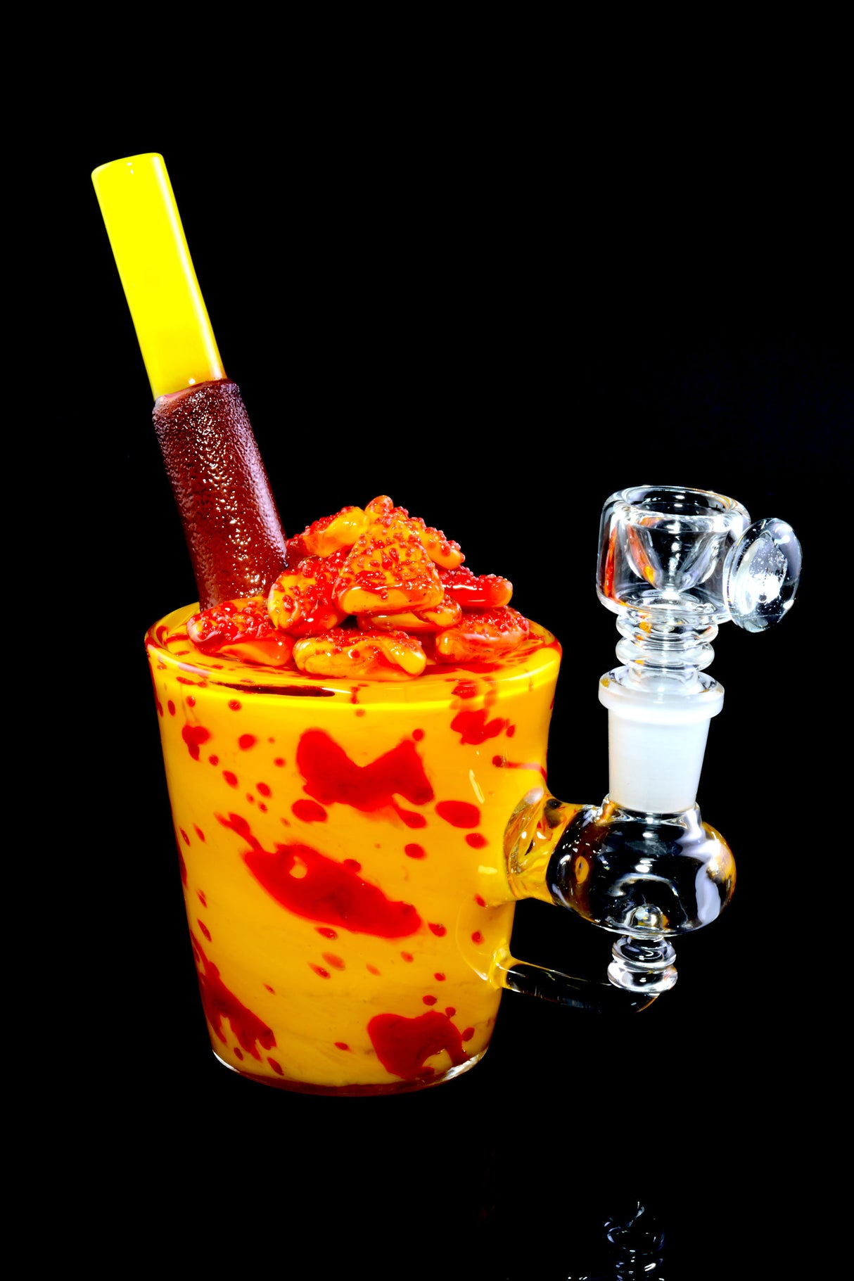 Dessert-themed glass mini rig on black background showing mango chunks, straw mouthpiece, and reinforced joint.
