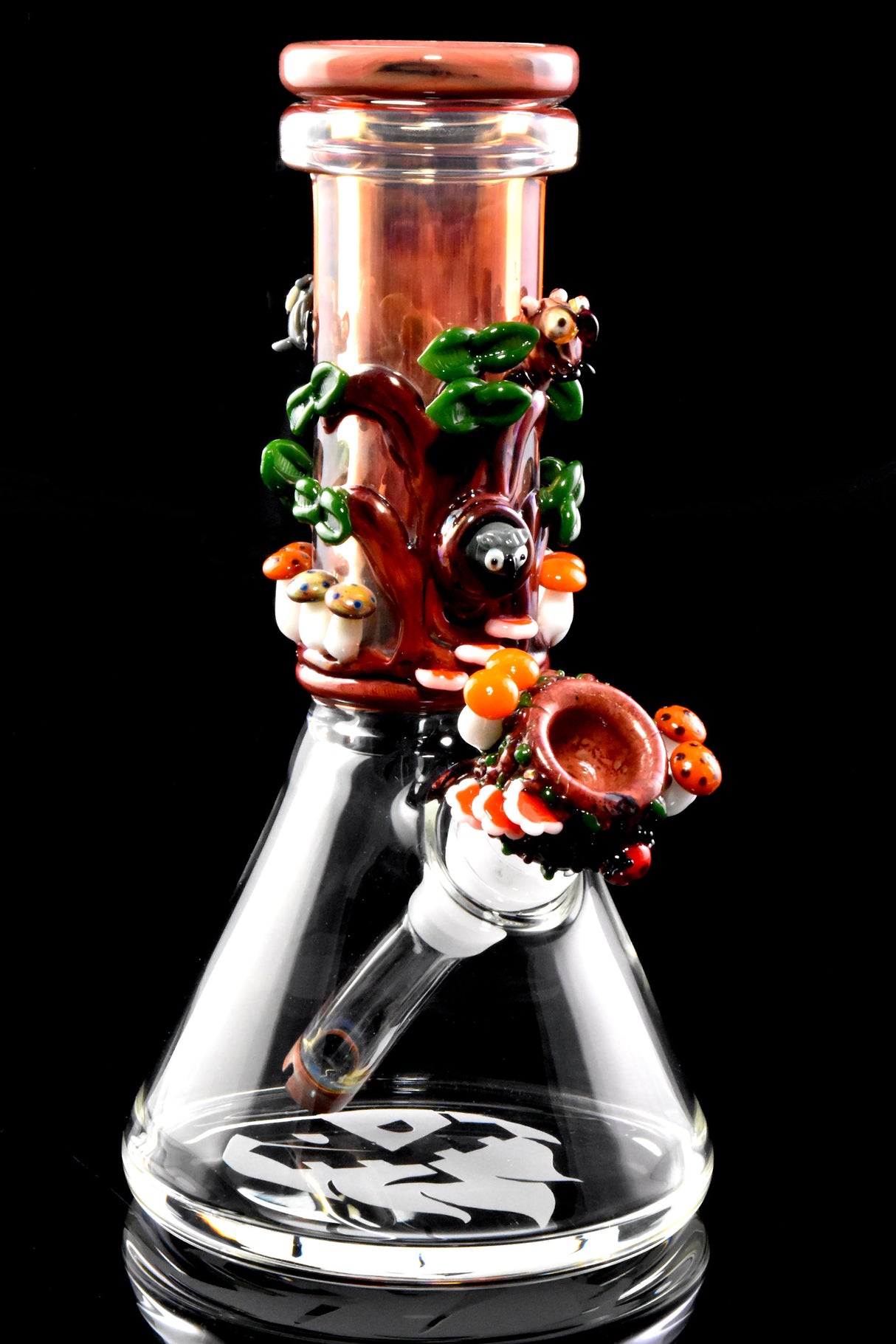 Redwood-themed baby beaker bong on black background showing worked tree, mushrooms, and matching bowl on angled downstem.