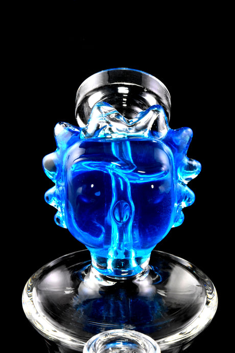 Close-up of blue fluid-filled “Ricky” character mouthpiece atop a compact glass bong, glossy face details visible.
