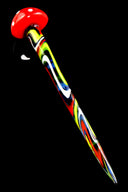Single red-cap striped mushroom dab tool with psychedelic yellow, blue, and green stem, angled on glossy black surface.