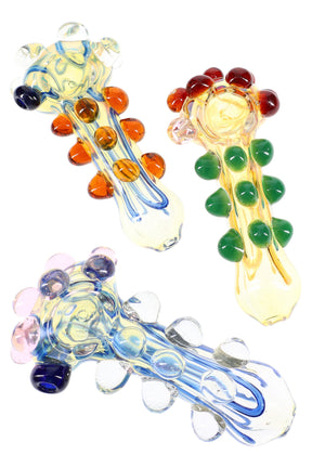 Five-inch color-changing glass spoon pipe with squiggle stripes and raised marbles along the handle and bowl, shown in assorted colors.