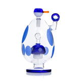 Rear profile of clear spotted egg novelty bong with blue pedestal foot and internal mushroom percolator visible through glass.