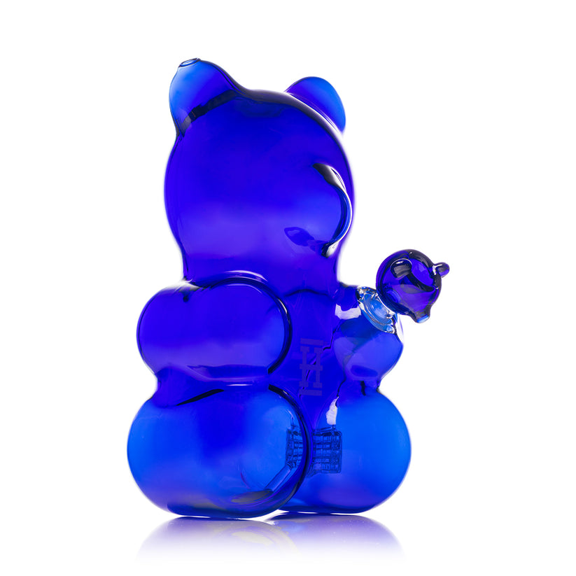Side angle of deep blue Hemper Gummy Bear XL glass bong with rounded gummy bear body and raised paw joint holding the bowl.