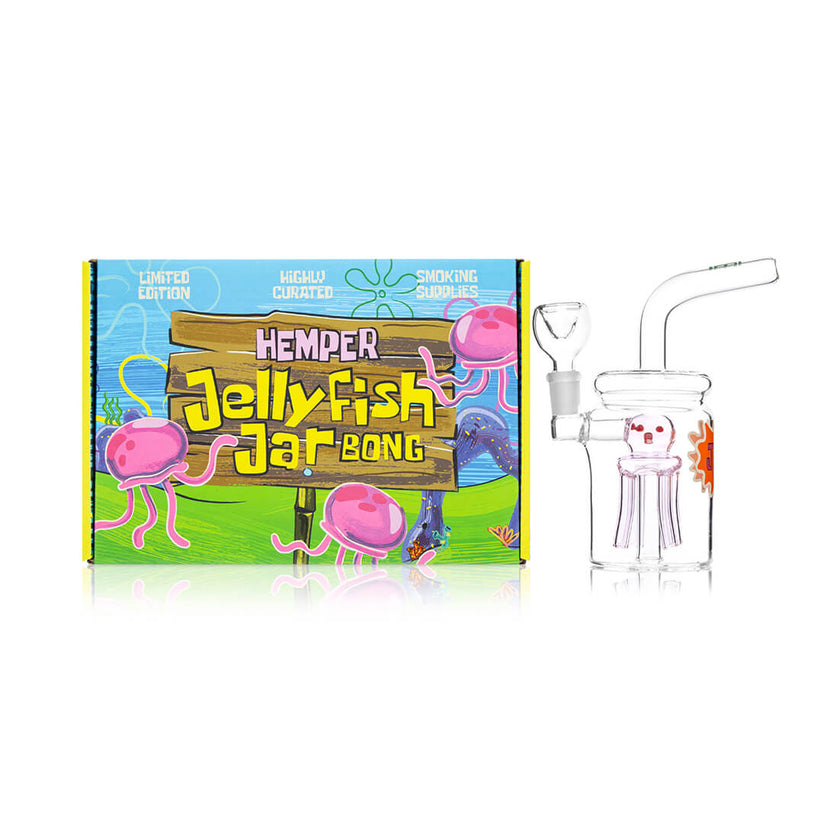 Hemper Jellyfish Jar bong with pink jellyfish perc posed next to colorful Jellyfish Jar Bong box, highlighting both novelty design and gift appeal.