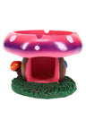 Hand-painted pink and purple mushroom-house resin ashtray with grassy base and two rest notches, compact 4-inch tabletop size.