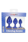 Cheeky Gems three-piece silicone butt plug set in deep blue with jewel bases, packaged in display box highlighting silky-smooth silicone.