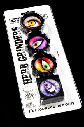 Retail blister pack of four eyeball-design mini plastic herb grinders, assorted shapes and colors, compact two-piece build with magnet.