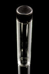 Compact 2.5 mL glass vial with twist cap positioned against deep black glossy surface, illustrating portability
