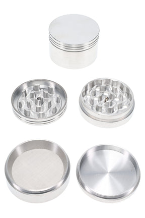 2¼″ 4-part metal herb grinder shown disassembled with magnetic lid, sharp teeth, mesh pollen screen, and deep kief catch base.