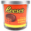 14-oz triple-wick Reese’s scented candle, rich brown wax jar wrapped in bold orange peanut-butter-cup label with steel cover
