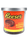 14-oz triple-wick Reese’s scented candle, rich brown wax jar wrapped in bold orange peanut-butter-cup label with steel cover
