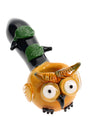 Front view of owl glass hand pipe with amber head, big eyes, beak, green leaves, and dark branch stem