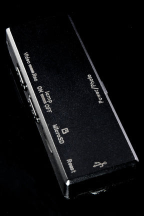 Slim black clip-on 1080p camera and voice recorder showing side control labels—video, lamp, micro SD, reset—on glossy black background