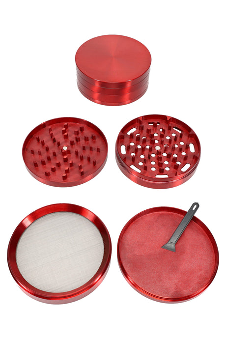 Red 100 mm 4-part zinc alloy herb grinder with magnetic lid removed, displaying internal grinding chamber.