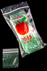 Clear mini zip baggies with bright-green dollar-sign print bundled in Apple Bags sleeve, isolated on black glass surface