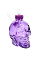 Bright purple 4-inch skull glass bong with matching top, clear bowl, and side straw mouthpiece standing upright