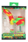 Rasta Ooze “Stack” silicone and glass dab rig in packaging, curved mouthpiece, raised grip texture, and included 14 mm accessories.