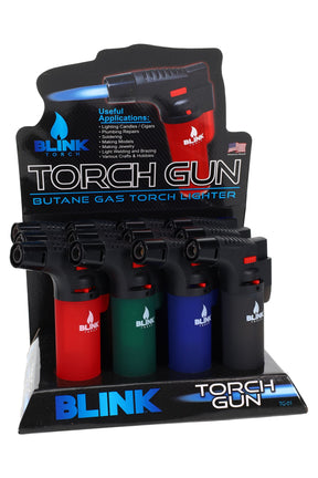 Retail display of 12 Blink Torch Gun butane lighters in assorted colors with straight nozzle, flame adjuster, and safety lock, checkout-ready.