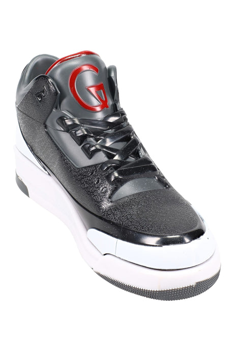 Close-up side view of sneaker herb grinder, laced black upper, red tongue logo, white midsole, realistic shoe detail.