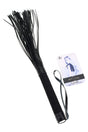 Black Nocturnal flogger with multiple soft falls, textured handle, and wrist loop shown with branded hang tag; beginner-friendly impact toy.