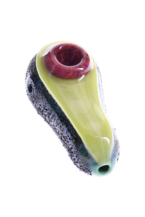 Avocado glass hand pipe with textured dark-green rind, red-brown pit bowl, and bright green body on white