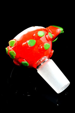 Close-up dragon fruit glass bowl slide showing red shell with raised green dots and frosted 14.5 mm male joint on black backdrop.
