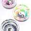 Round glass ashtray trio featuring yin-yang mandala, rainbow petal palette and black-white tribal art; clear 4-inch design with three rest notches, top view.