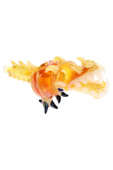 Side view of gold fumed dragon hand pipe showing sculpted head, black claws, and textured tail