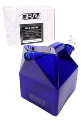 GRAV Milk Carton Bubbler in deep blue glass with straw-style mouthpiece and included 14 mm Cup Bowl, shown beside retail box.