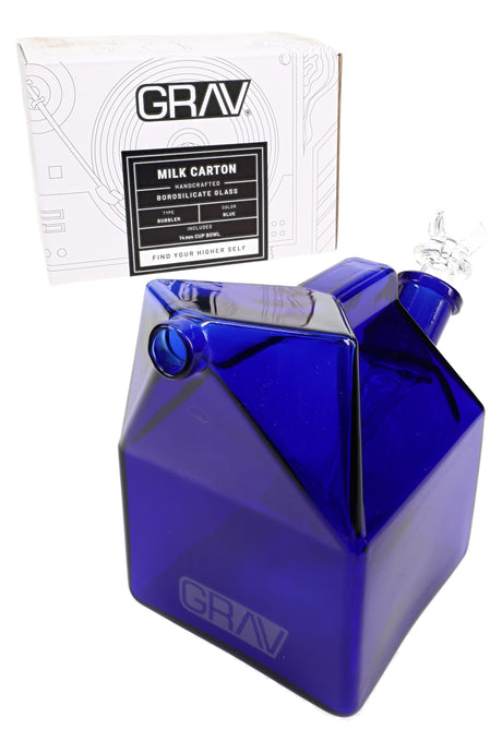 GRAV Milk Carton Bubbler in deep blue glass with straw-style mouthpiece and included 14 mm Cup Bowl, shown beside retail box.