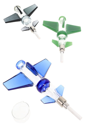 Plane-shaped glass dab straw kit with colored blue, green, and gray wings, screw-on ceramic tips, and a small round concentrate dish on white background