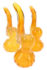 Three gold fumed glass Sherlock bubblers showing honey amber color, curved necks, and raised accents