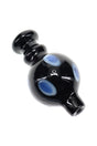 Glossy black glass bubble carb cap with blue dotted accents, rounded handle, and short spout for directing airflow on a quartz banger.