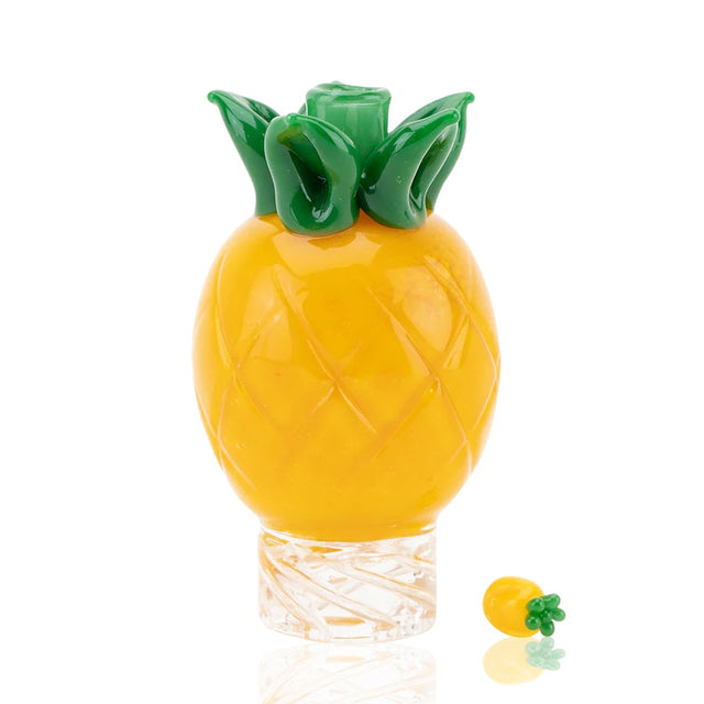 Front view of yellow pineapple spinner cap with green crown and clear spinner base, shown with matching terp pearl.