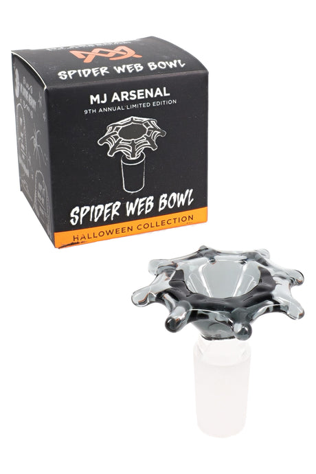 MJ Arsenal spiderweb glass flower bowl beside Halloween box, 14.5 mm male joint and raised webbed rim for dry herb setups.