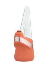 Puffco New Peak smart e-rig in limited Canyon orange with rose-metal band, clear conical glass top and joystick cap shown from front.